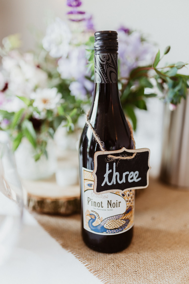 Wine Bottle Table Number Name Chalk Black Board Beautifully Relaxed Outdoorsy Barn Wedding http://www.caitlinandjones.co.uk/ 