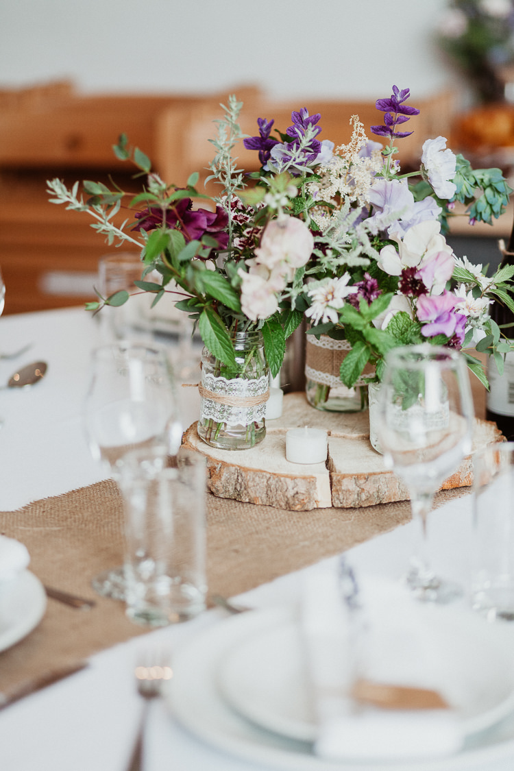 Centrepiece Decor Table Jars Hessian Lace Flowers Log Beautifully Relaxed Outdoorsy Barn Wedding http://www.caitlinandjones.co.uk/ 