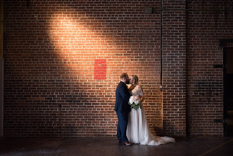 Bride Groom Kiss Romantic Industrial Studio Loft Georgia Wedding http://krisandraevans.com/