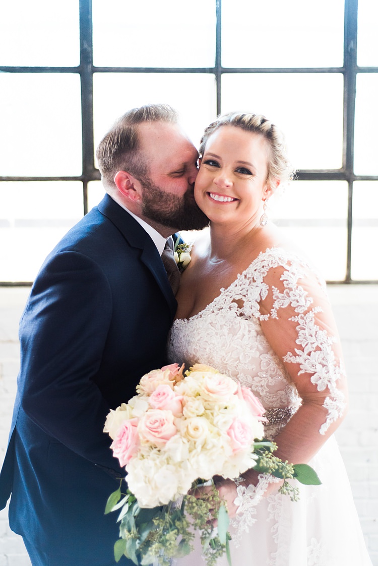 Bride Groom Kiss Cheek Lace Sleeves Romantic Industrial Studio Loft Georgia Wedding http://krisandraevans.com/ 