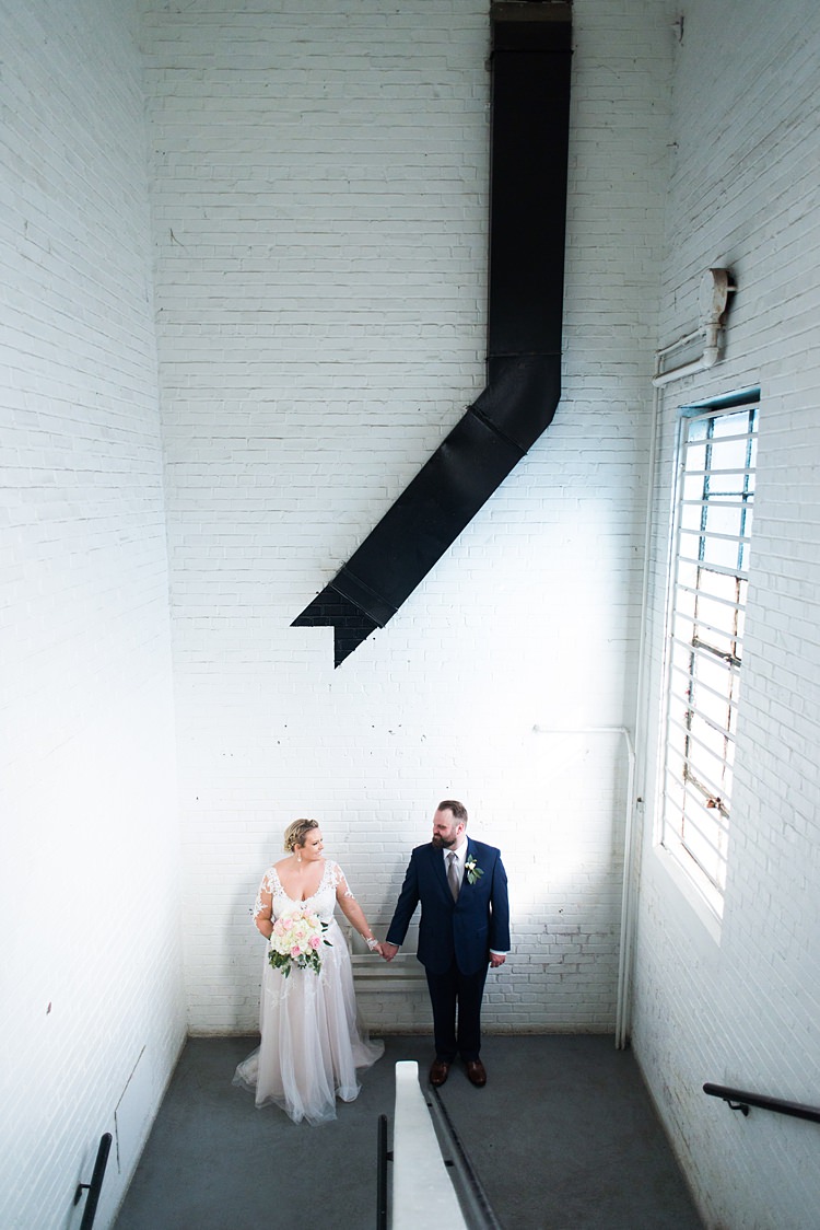 Bride Groom Handholding Romantic Industrial Studio Loft Georgia Wedding http://krisandraevans.com/