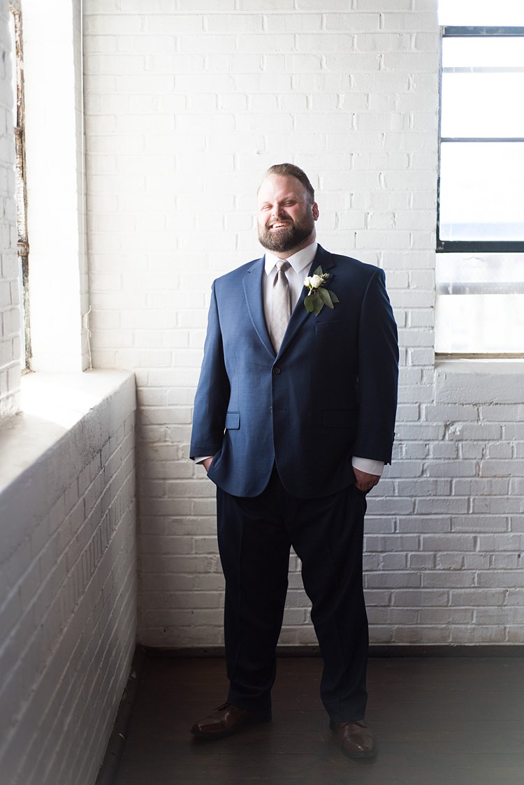 Groom Laughing Navy Suit Romantic Industrial Studio Loft Georgia Wedding http://krisandraevans.com/