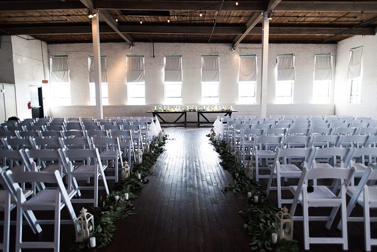 Ceremony White Chairs Lanterns Aisle Romantic Industrial Studio Loft Georgia Wedding http://krisandraevans.com/