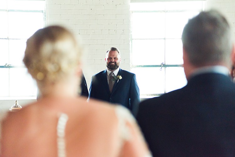 Bride Aisle Smiling Groom Romantic Industrial Studio Loft Georgia Wedding http://krisandraevans.com/