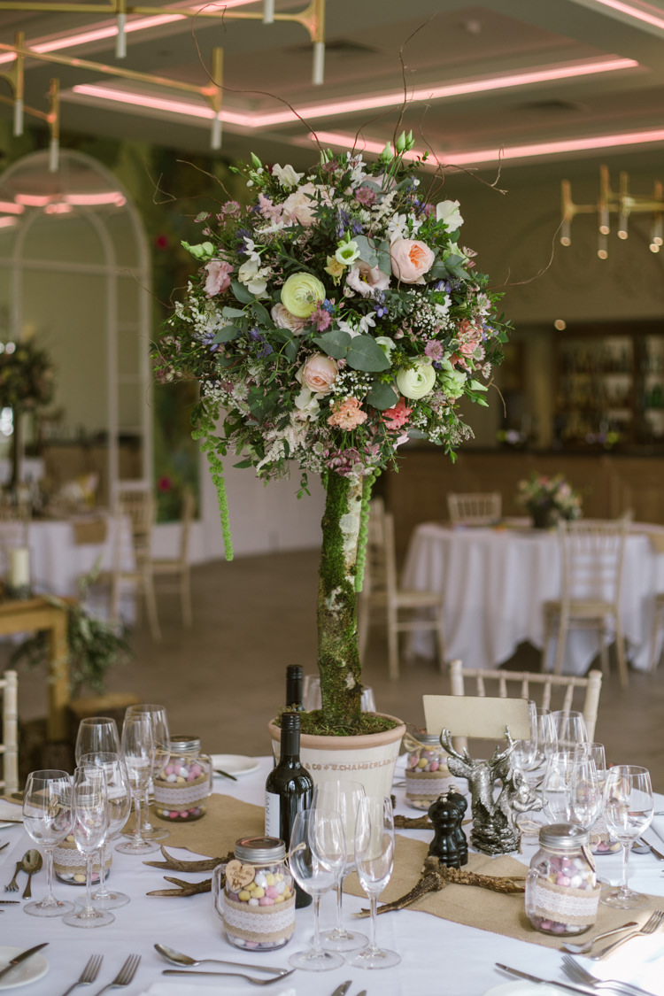 Table Centre Floral Arrangement Pedestal Greenery Pastel Orange Purple Rose Greenery Mini Eggs Easter Spring Woodland Wedding http://emmastonerweddings.com/