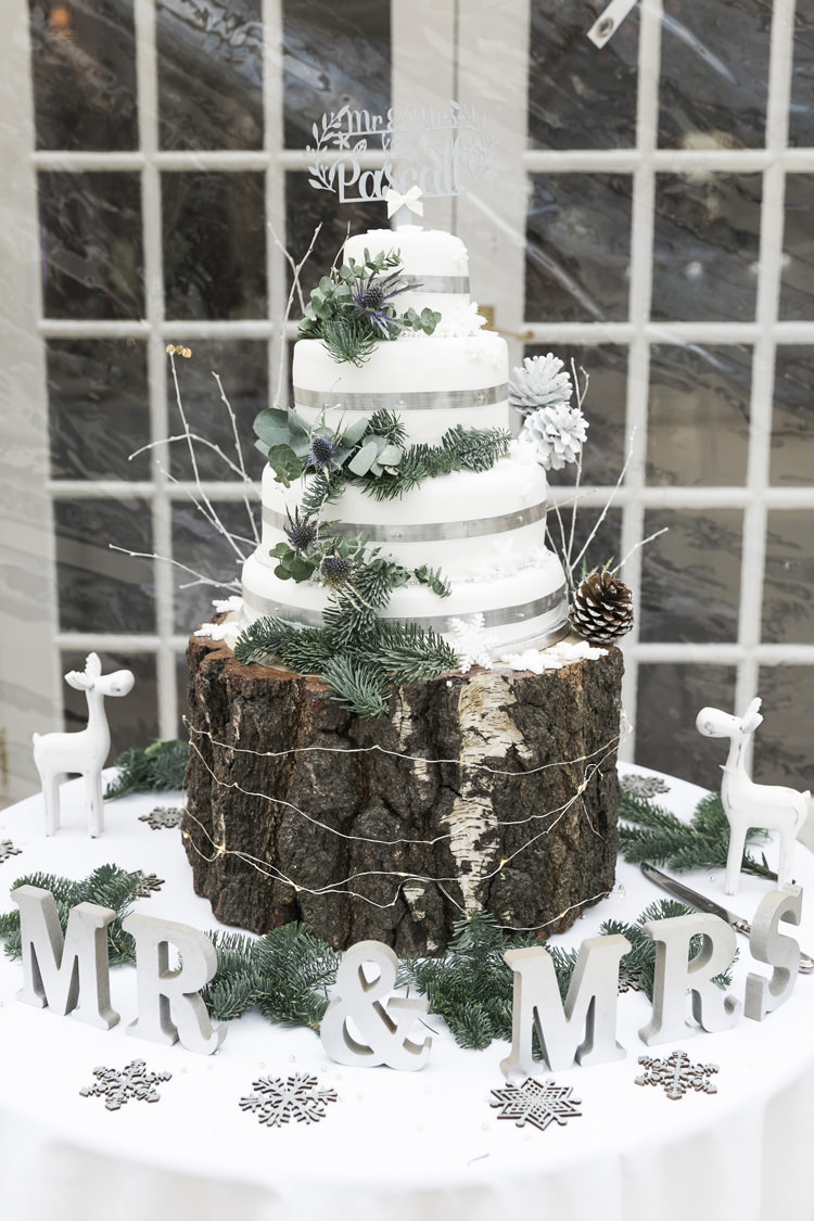 Cake Table Wood Slice Rustic Pine Greenery White Silver Gorgeously Glam New Years Eve Wedding http://www.photographybykrishanthi.co.uk/