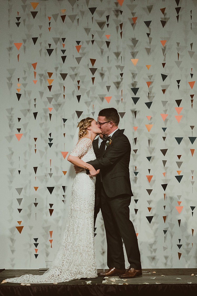 Geometric Hanging Paper Triangle Backdrop Ceremony Hip Art Gallery Wedding Colorado http://www.lisarundallphotography.com/