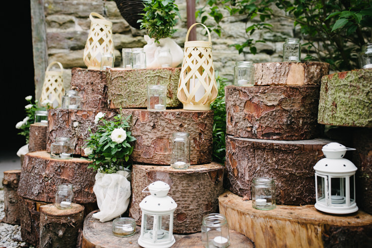 Wood slice Pile Lanterns Tealights Jars Entrance Rustic DIY Wedding at Home in the Peak District http://www.peakography.co.uk/