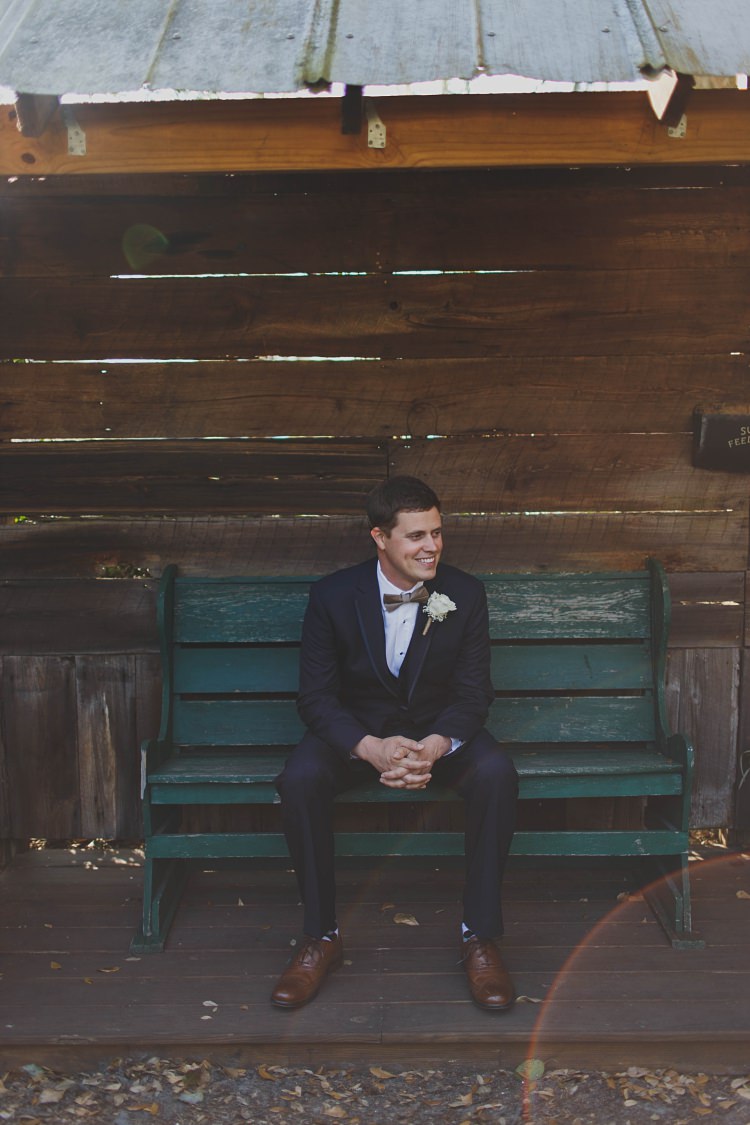Groom Sitting Bow Tie Navy Glam Twinkling Ranch Wedding Florida https://www.stacypaulphotography.com/