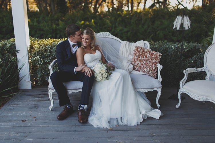 Bride Groom Kiss Sitting Sofa Glam Twinkling Ranch Wedding Florida https://www.stacypaulphotography.com/
