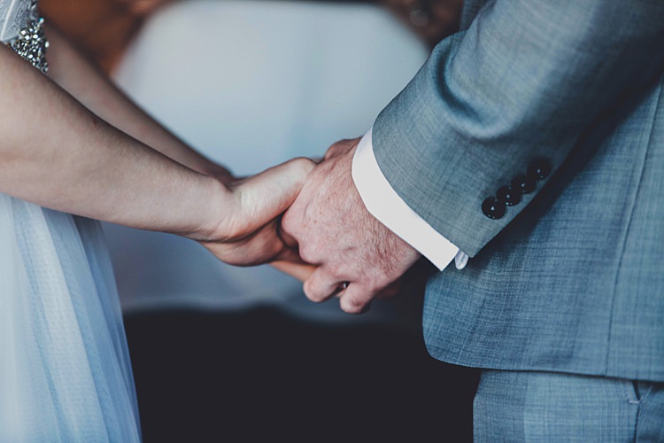 Bride Groom Holding Hands Ceremony Windy Valley of Fire Wedding Nevada https://cactusandlaceweddings.com/
