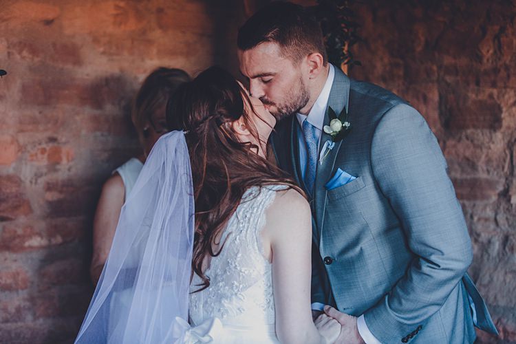 Bride Groom Ceremony Kiss Windy Valley of Fire Wedding Nevada https://cactusandlaceweddings.com/