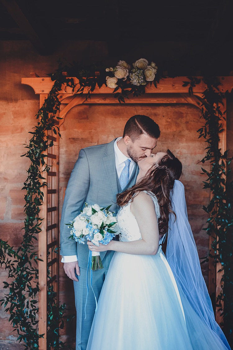 Bride Groom Ceremony Kiss Archway Windy Valley of Fire Wedding Nevada https://cactusandlaceweddings.com/