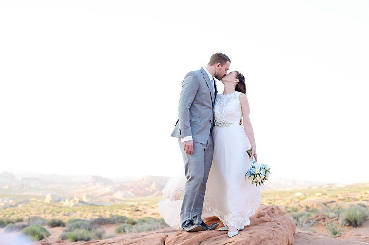 Bride Groom Kiss Windy Valley of Fire Wedding Nevada https://cactusandlaceweddings.com/