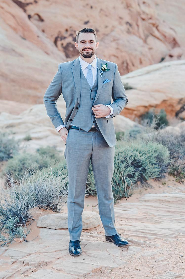 Groom Blue Grey Windy Valley of Fire Wedding Nevada https://cactusandlaceweddings.com/