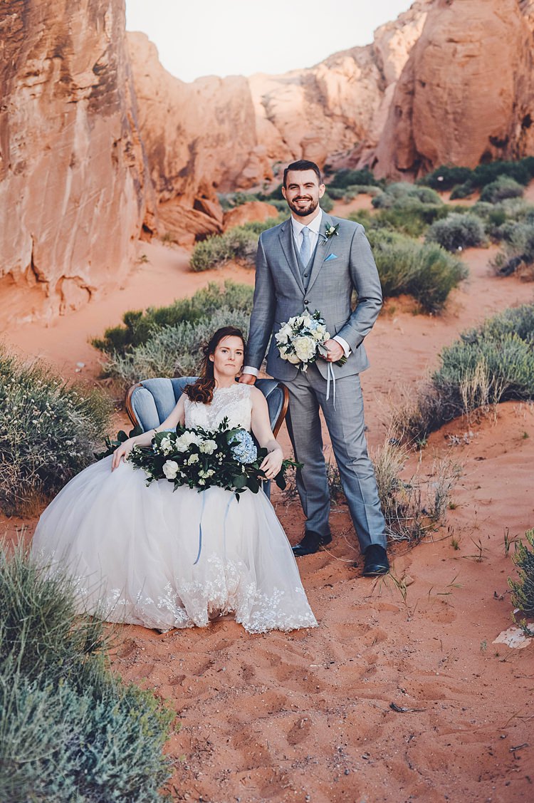 Bride Groom Flowers Chair Blue Pose Windy Valley of Fire Wedding Nevada https://cactusandlaceweddings.com/