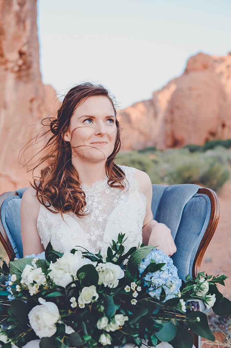 Bride Blue Chair Windy Valley of Fire Wedding Nevada https://cactusandlaceweddings.com/
