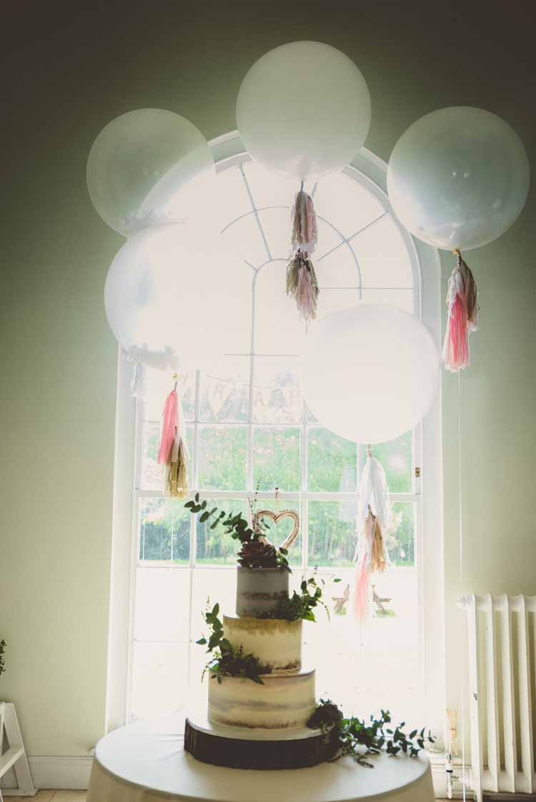 Giant Latex Balloons Paper Tassels Helium Cake Table Half Naked Foliage Eclectic Floral Fun Wedding http://www.photographybypaloma.co.uk/