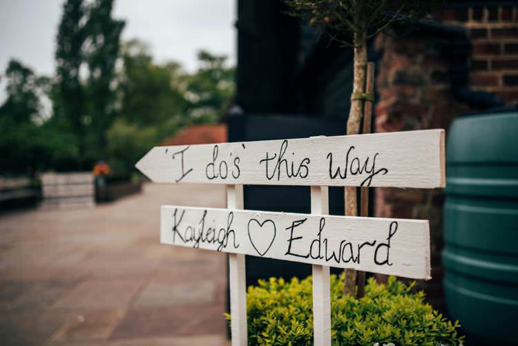Rustic Painted Sign Post Colourful Hand Made Rustic Barn Flower Filled Wedding http://www.threeflowersphotography.co.uk/