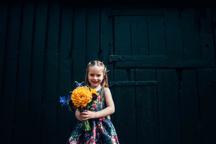 Floral Flower Girl Dress Colourful Hand Made Rustic Barn Flower Filled Wedding http://www.threeflowersphotography.co.uk/