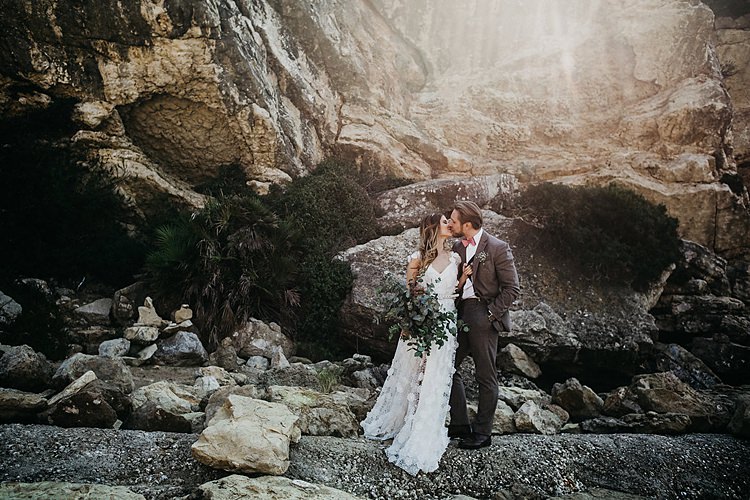 Bride Groom Kiss Rocks Beach Whimsical Greenery Wedding Ideas Sea http://eglejo.lt/