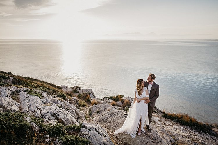 Bride Groom Embrace Rocks Beach Whimsical Greenery Wedding Ideas Sea http://eglejo.lt/