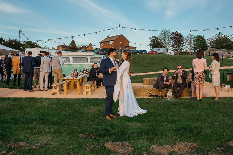 Bride Bridal 1970s Dress Gown Mum's Vintage Bespoke Groom Festoon Lighting Hay Bales Wooden Bench Table Outdoor Farm Wedding 1970s Dress https://www.magdak.co.uk/