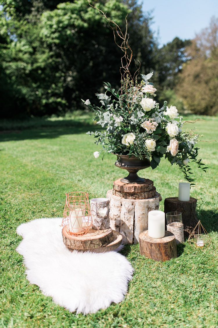 Foliage Flowers Roses Sheepskin Logs Decor Urn Bohemian Garden Greenery Wedding Ideas http://www.storytellerphotography.co.uk/