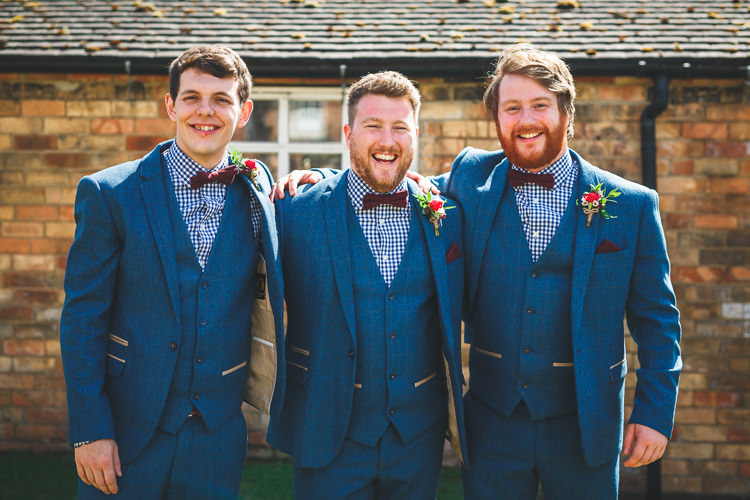Groom Groomsmen Three Piece Marc Darcy Suit Burgundy Bow Tie Pocket Square Waistcoat Gingham Shirt Blue Rustic Barn Red Gold Glam Wedding https://garethnewsteadphotography.com/
