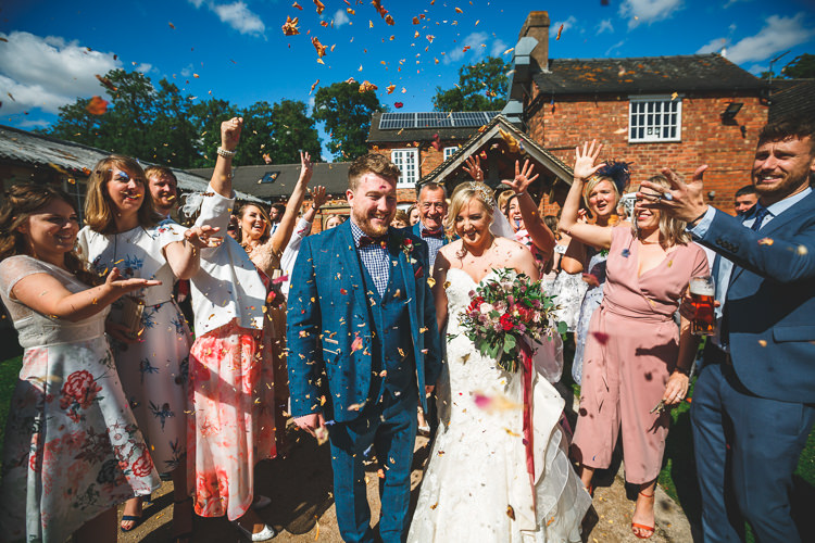 Confetti Shot Bride Bridal Sottero & Midgley Dress Gown Sweetheart Neckline Marc Darcy Groom Three Piece Waistcoat Bouquet Ribbon Rustic Barn Red Gold Glam Wedding https://garethnewsteadphotography.com/