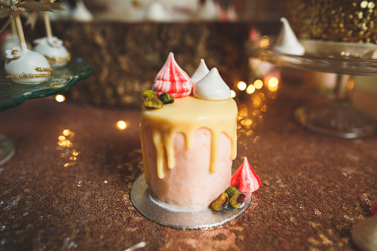 Cake Table Sequin Sparkly Rose Gold Drip Meringue Kiss Glass Stand Cake Pops Rustic Barn Red Gold Glam Wedding https://garethnewsteadphotography.com/