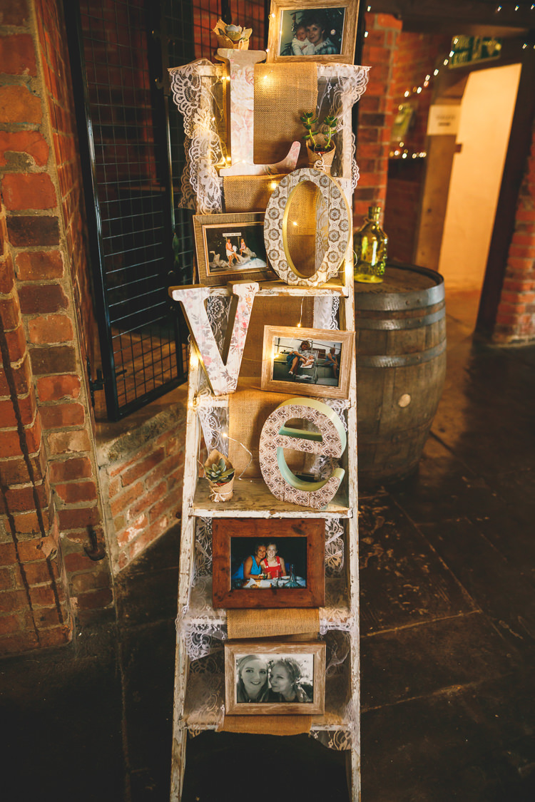 Stepladder Display LOVE Lace Photographs Memories Fairy Lights Rustic Barn Red Gold Glam Wedding https://garethnewsteadphotography.com/