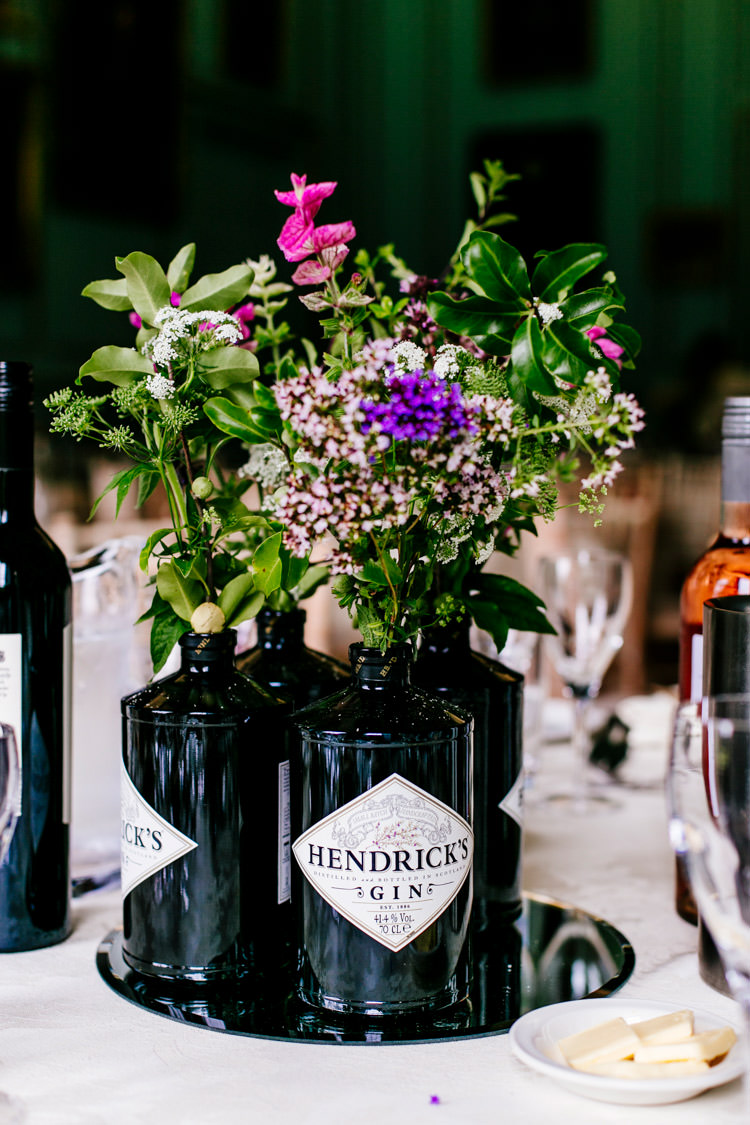 Centrepiece Gin Bottles Floral Flowers Purple Mirror Centre Hendricks Stylish Sassy Gin Wedding http://epiclovestory.co.uk/