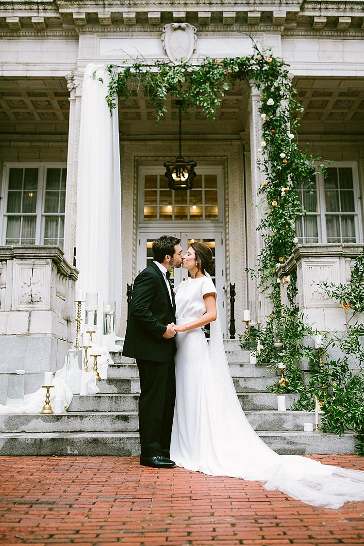 Bride Groom Kiss Black Tie Long Veil Short Sleeve Dress Plain Greenery Steps Candles Gold Modern Elegance Marble Greenery Gold Wedding Ideas http://www.jettwalkerphotography.com/