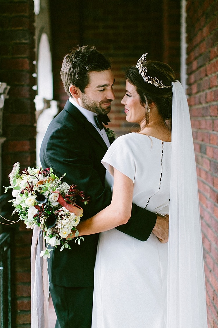 Black Tie Groom Bride Short Sleeve Plain Dress Buttons Long Veil Up Do Gold Tiara Headpiece Bouquet Roses Greenery Modern Elegance Marble Greenery Gold Wedding Ideas http://www.jettwalkerphotography.com/