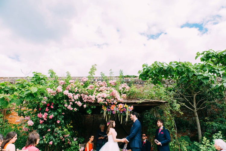 Flower Arch Backdrop Ceremony Colourful Mexican Garden Wedding http://jennifersmithphotography.co.uk/
