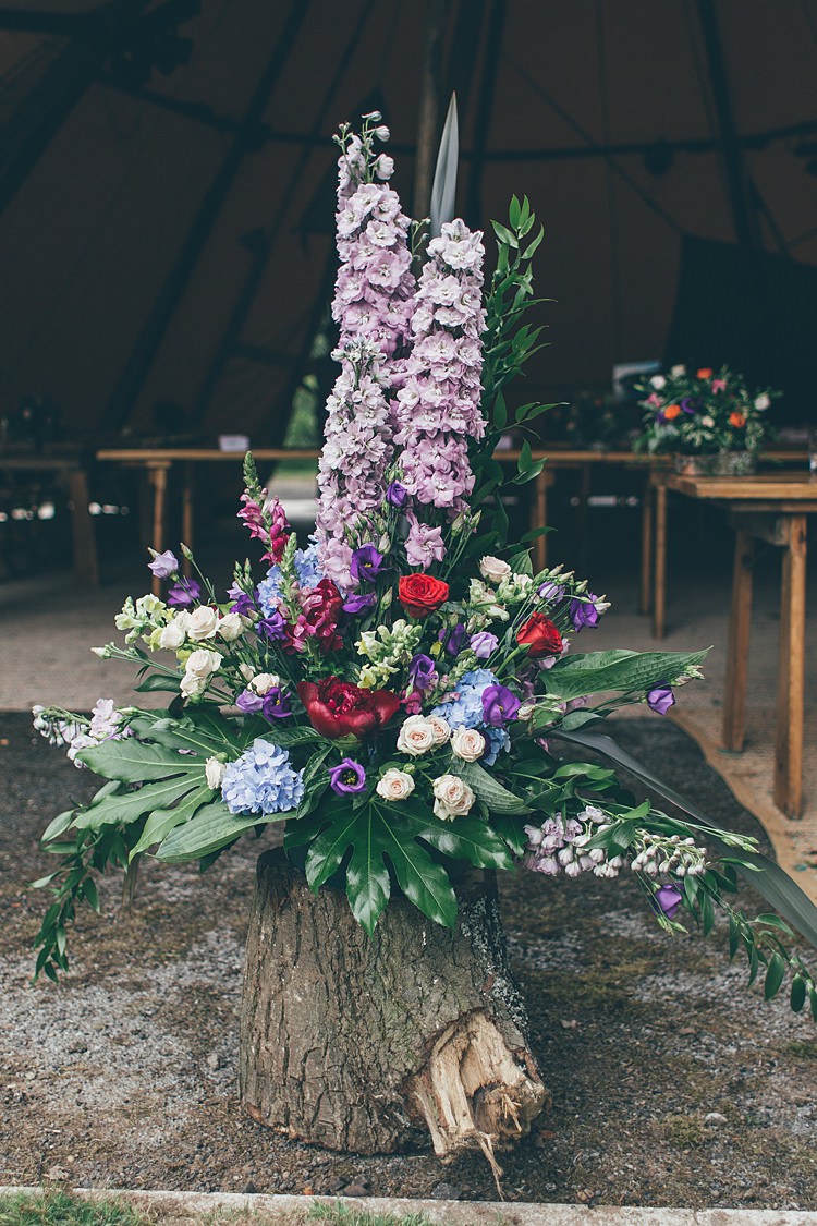 Flower Arrangement Tall Log Purple Red Blue Pink Beautiful Floral Bohemian Garden Wedding http://rachellambertphotography.co.uk/