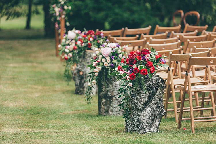 Pew End Aisle Flowers Log Chairs Rose Purple Red Pink Beautiful Floral Bohemian Garden Wedding http://rachellambertphotography.co.uk/