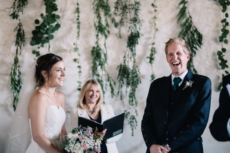 Hanging Greenery Backdrop Ceremony Twinkling Rustic DIY Barn Wedding https://www.harperscottphoto.com/