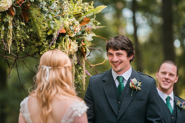 Bride Groom Ceremony Laughter Green Tie Thistle Buttonhole Bestman Outdoor Archway Foliage Whimsical Woods Wedding Barn Ohio http://www.connectionphotoblog.com/