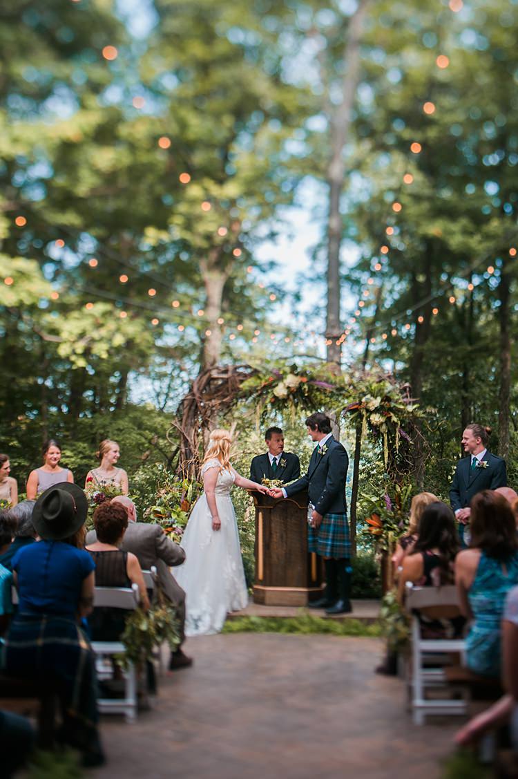 Aisle Festoon Lighting Ceremony Bride Groom Hand Holding Guests Vows Whimsical Woods Wedding Barn Ohio http://www.connectionphotoblog.com/