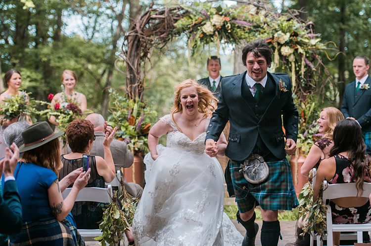 Bride Groom Running out of Ceremony Vows Tartan Kilt Dress Cap Sleeve Lace Curls Archway Branches Whimsical Woods Wedding Barn Ohio http://www.connectionphotoblog.com/
