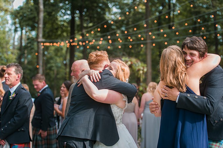 Bride Groom Guests Hugs Festoon Lighting Forest Outdoors Kilts Whimsical Woods Wedding Barn Ohio http://www.connectionphotoblog.com/