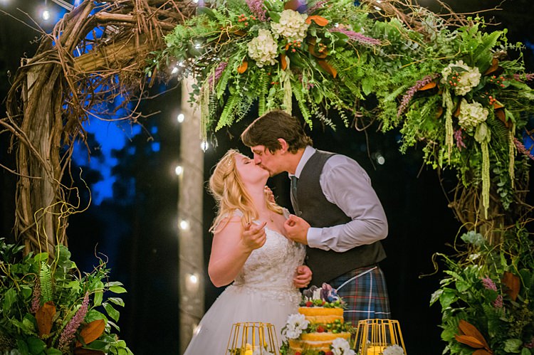 Bride Groom Festoon Lighting Naked Cake Display Outdoors Archway Branches Whimsical Woods Wedding Barn Ohio http://www.connectionphotoblog.com/
