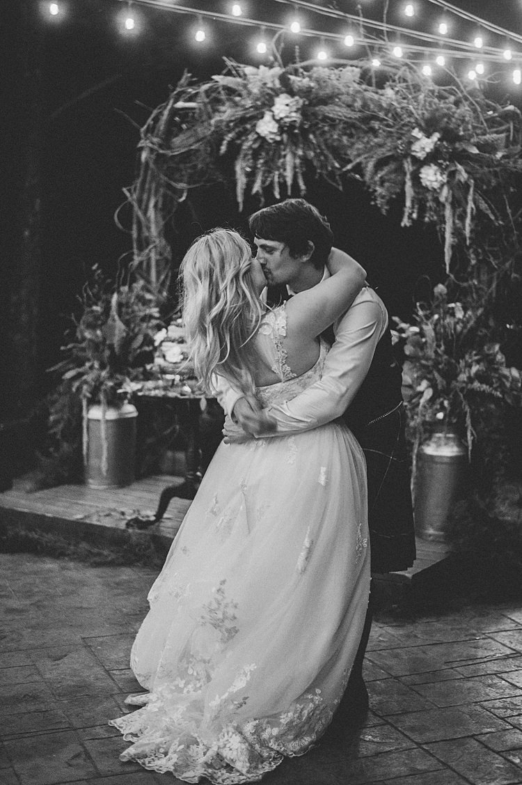 Bride Groom Kiss Embrace Lace A Line Gown Cap Sleeve Outdoors Festoon Lighting Archway Greenery Whimsical Woods Wedding Barn Ohio http://www.connectionphotoblog.com/