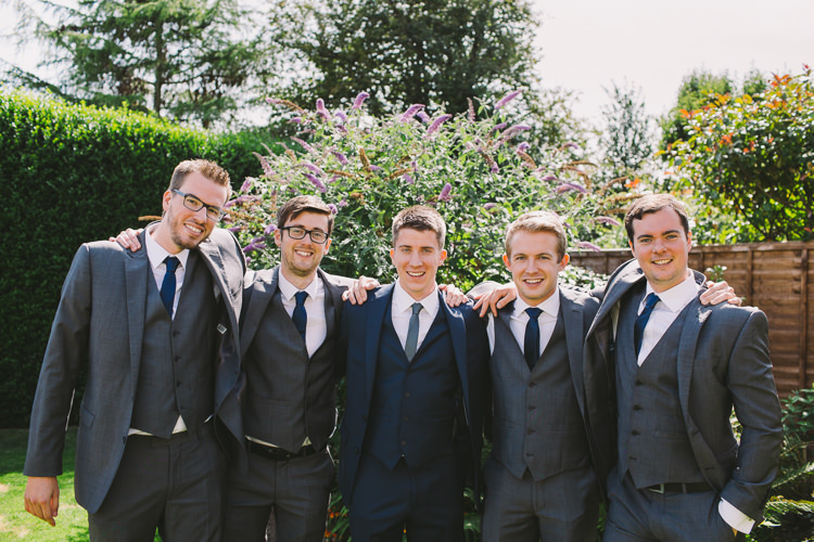 Groom Groomsmen Usher Best Man Moss Bros Navy Suit Grey Three Piece Waistcoat Blue Tie Fairy Lights Vibrant Florals Summer Barn Wedding https://www.oliviajudah.co.uk/
