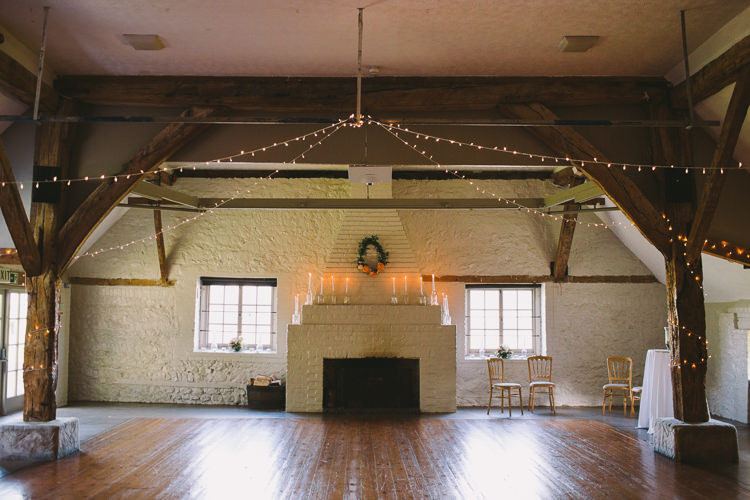 Pea Lights Candles Wreath Fireplace Fairy Lights Vibrant Florals Summer Barn Wedding https://www.oliviajudah.co.uk/
