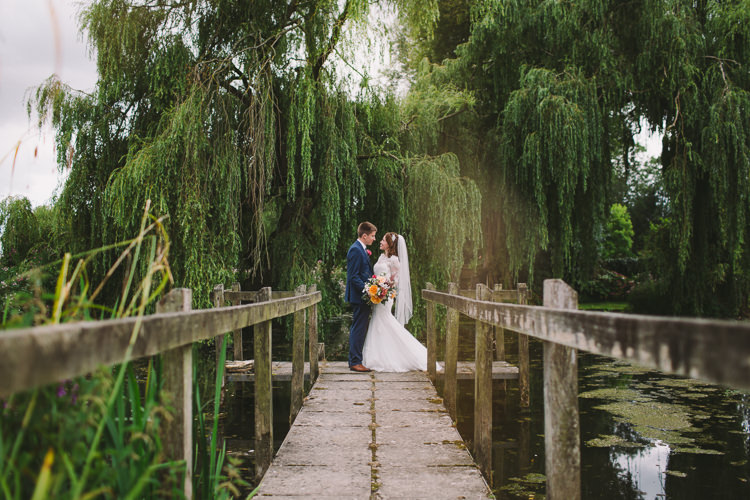 Bride Bridal Dress Gown Sweetheart Neckline Lace Jacket Diamante Belt Moss Bros Groom Navy Suit Three Piece Waistcoat Bouquet Dahlia Rose Berries Greenery Fairy Lights Vibrant Florals Summer Barn Wedding https://www.oliviajudah.co.uk/