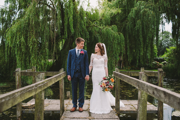 Bride Bridal Dress Gown Sweetheart Neckline Lace Jacket Diamante Belt Moss Bros Groom Navy Suit Three Piece Waistcoat Bouquet Dahlia Rose Berries Greenery Fairy Lights Vibrant Florals Summer Barn Wedding https://www.oliviajudah.co.uk/