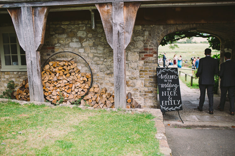 Welcome Sign Chalk Blackboard Modern Calligraphy Easel Signage Fairy Lights Vibrant Florals Summer Barn Wedding https://www.oliviajudah.co.uk/